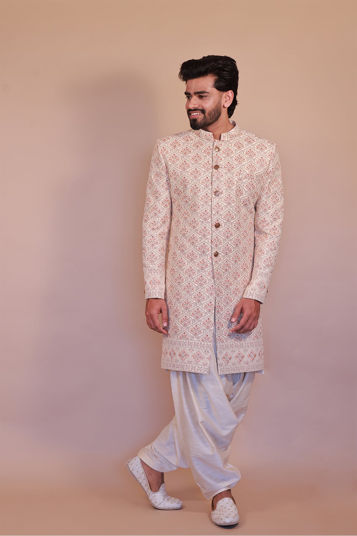 Cream Sherwani for Grooms with Stunning Orange-Gold Detailing